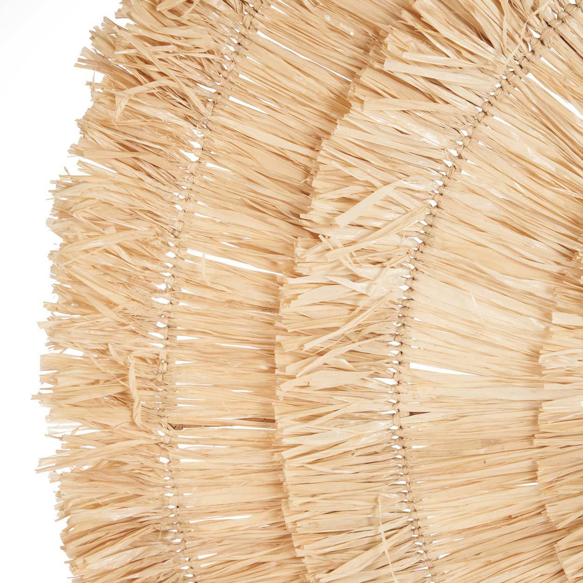 Gros plan sur les couronnes de franges de sisal de la décoration murale Sehseh