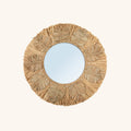 Miroir Palmier rond entouré de feuilles et de franges de raphia, vue de face